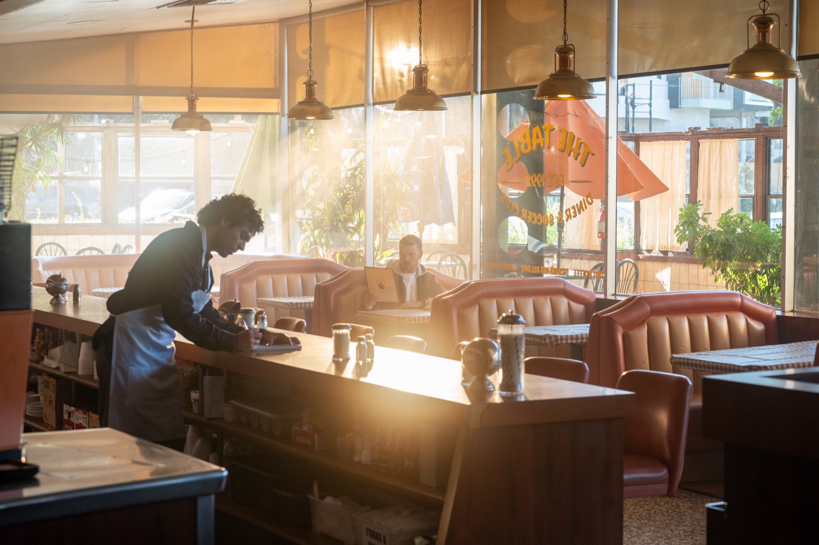 Ozzie Jauregui and Will Poulter in the Premier League commercial diner scene