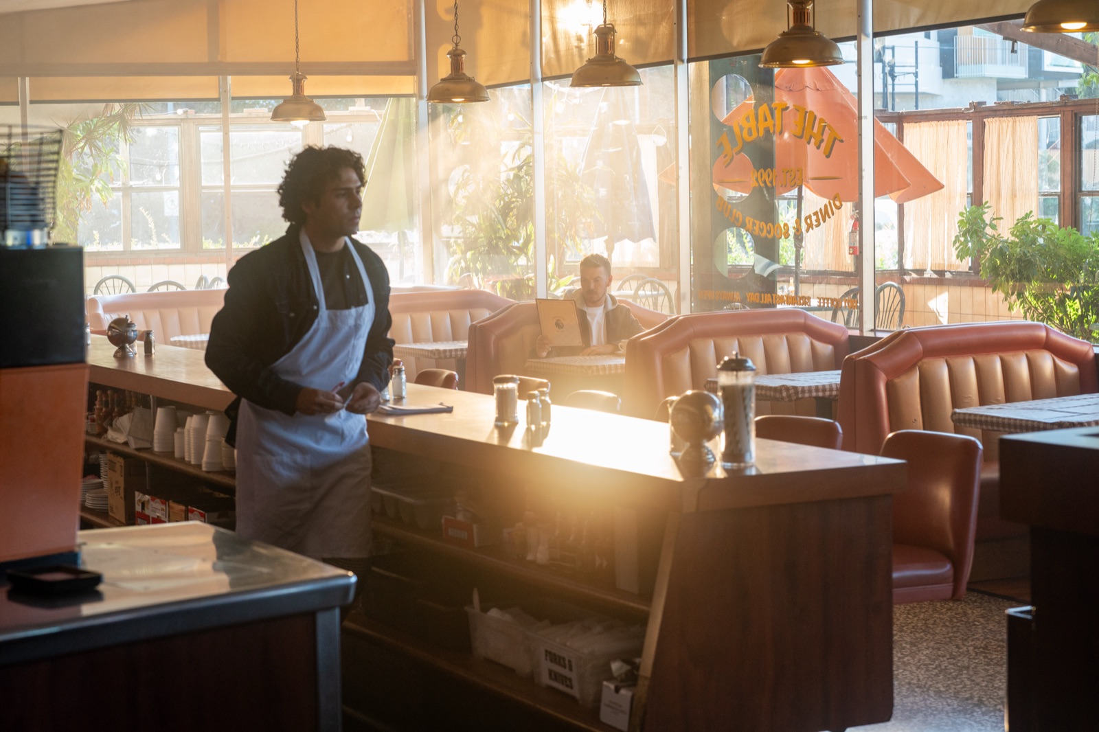 Ozzie Jauregui as the Waiter on the set of the Premier League national commercial